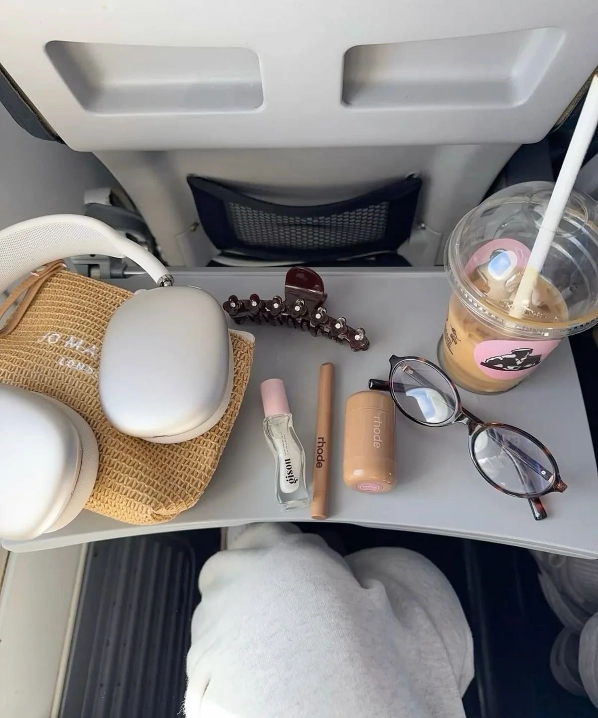 Travel beauty essentials on a tray table
